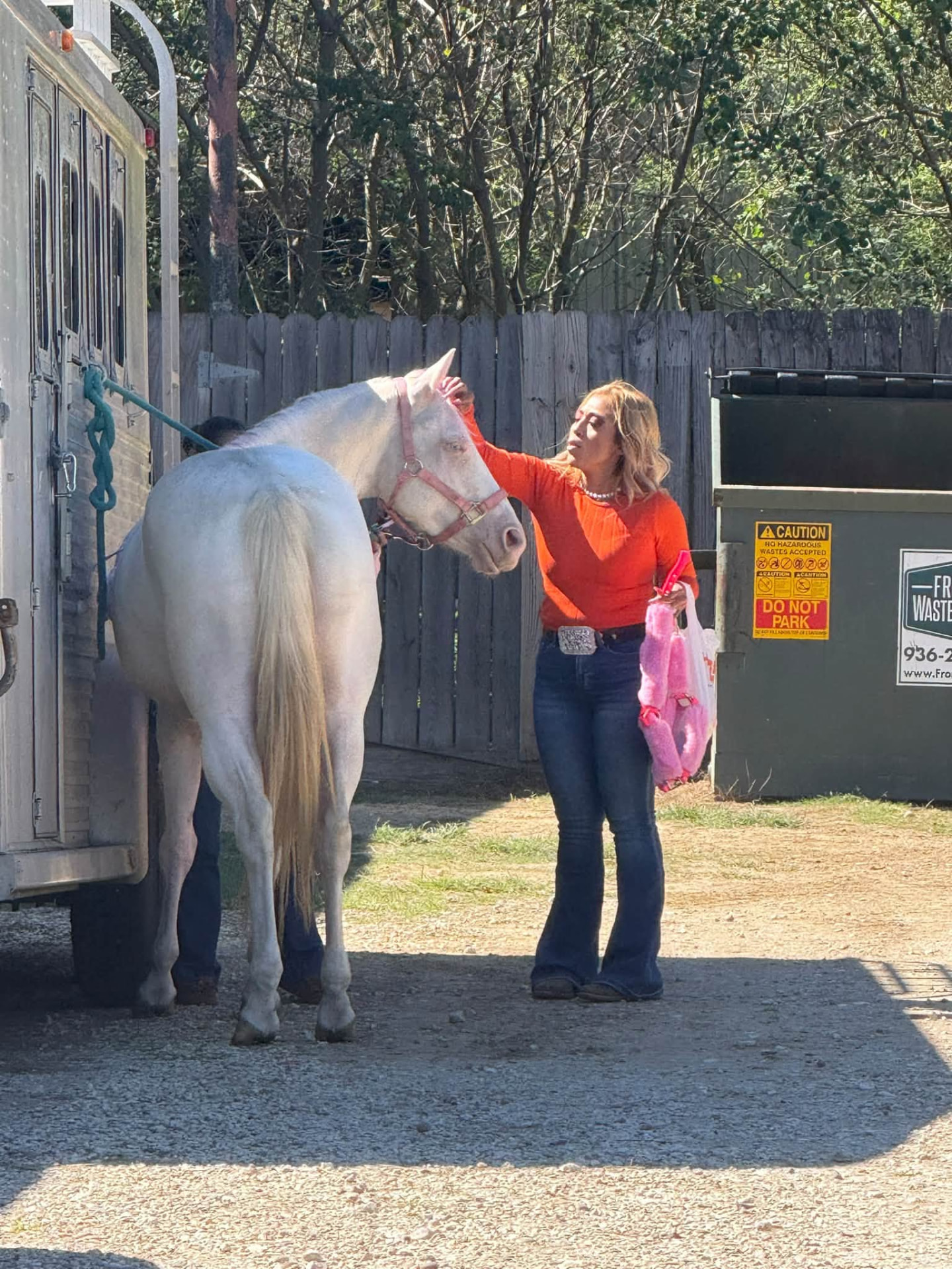 Owner standing with a white horse