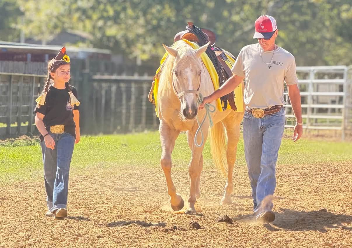 Young rider leading a palomino